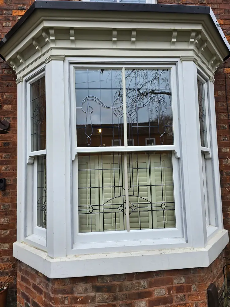 Bay window with sliding sashes and leaded glazing