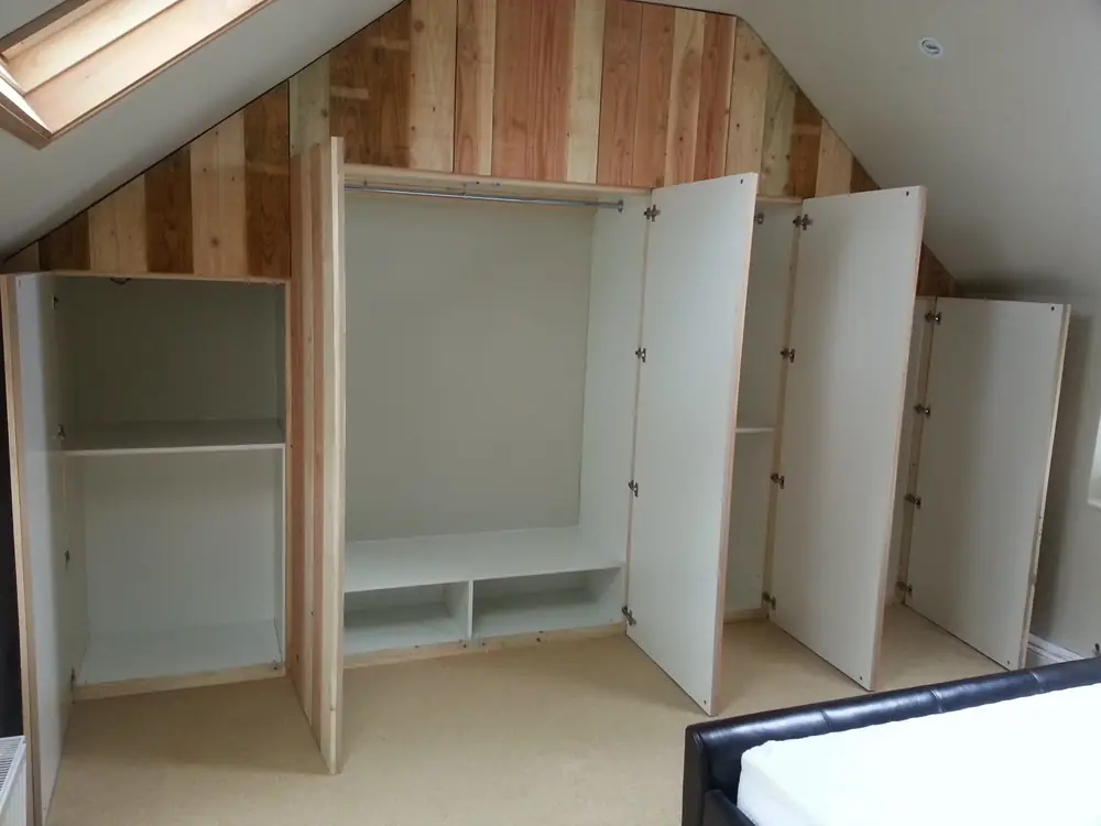 Fitted wardrobes under a sloping ceiling